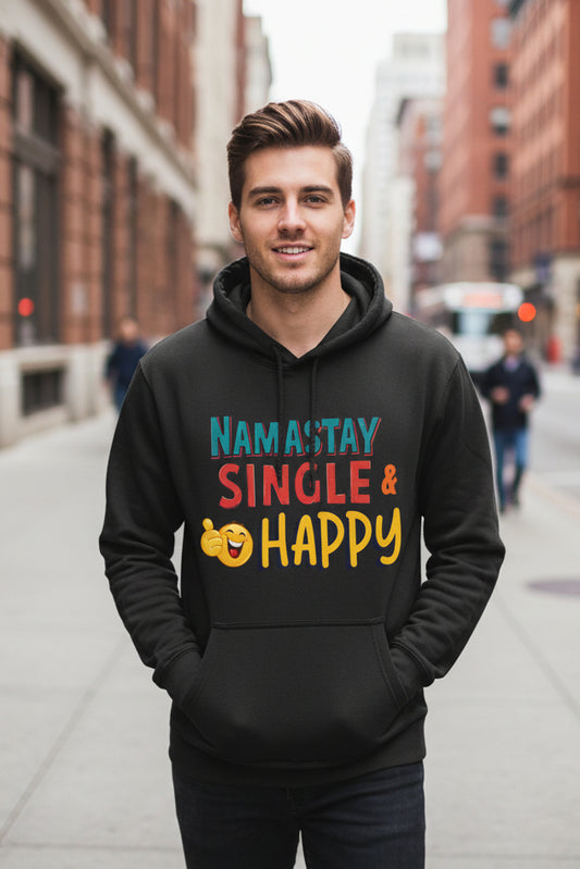 A dark charcoal gray pullover hoodie with a colorful graphic on the chest that reads 'NAMASTAY SINGLE & HAPPY' in blue, red, and yellow lettering, accompanied by a yellow smiling emoji. The hoodie is shown against a plain white background.