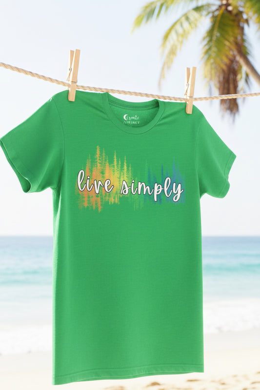 A green short-sleeve crewneck t-shirt featuring a chest graphic with the words 'live simply' in white script over a colorful, blurred vertical tree pattern in yellow, orange, and blue. The brand name 'Cute Animals' is printed inside the collar.