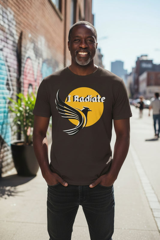 A dark brown short-sleeve t-shirt with a graphic on the chest featuring a yellow sun, a stylized bird, and the text 'I Radiate' in white.
