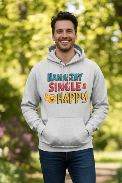 A light heather gray pullover hoodie with a colorful graphic on the chest that reads 'NAM A STAY SINGLE & HAPPY' with a yellow emoji face, shown on a plain white background.