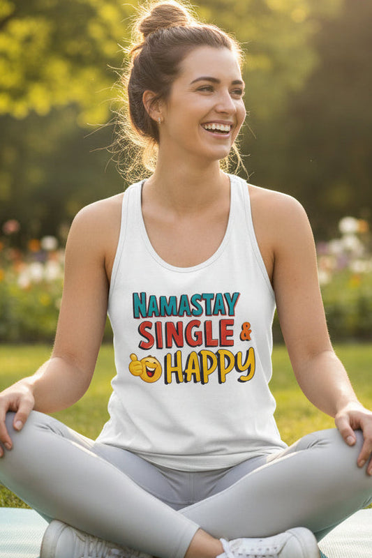 A white racerback tank top featuring a colorful graphic print on the front that reads 'NAMASTAY SINGLE & HAPPY' with a yellow emoji face, shown against a plain white background.