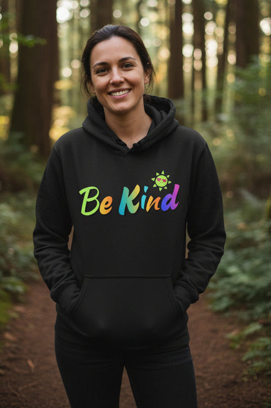 A dark charcoal gray pullover hoodie with a colorful graphic on the chest that reads 'Be Kind' in a rainbow gradient, accompanied by a small smiling sun character. The hoodie is shown against a plain white background.